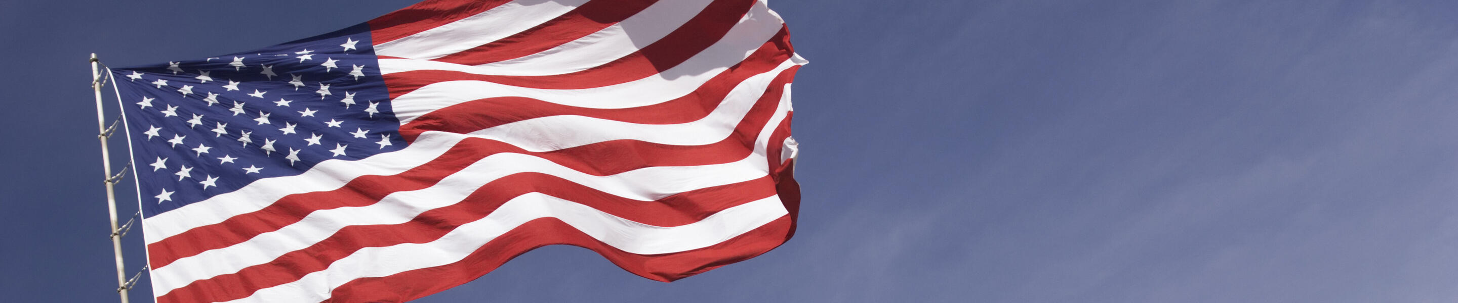 United States of America flag on pole blowing in wind
