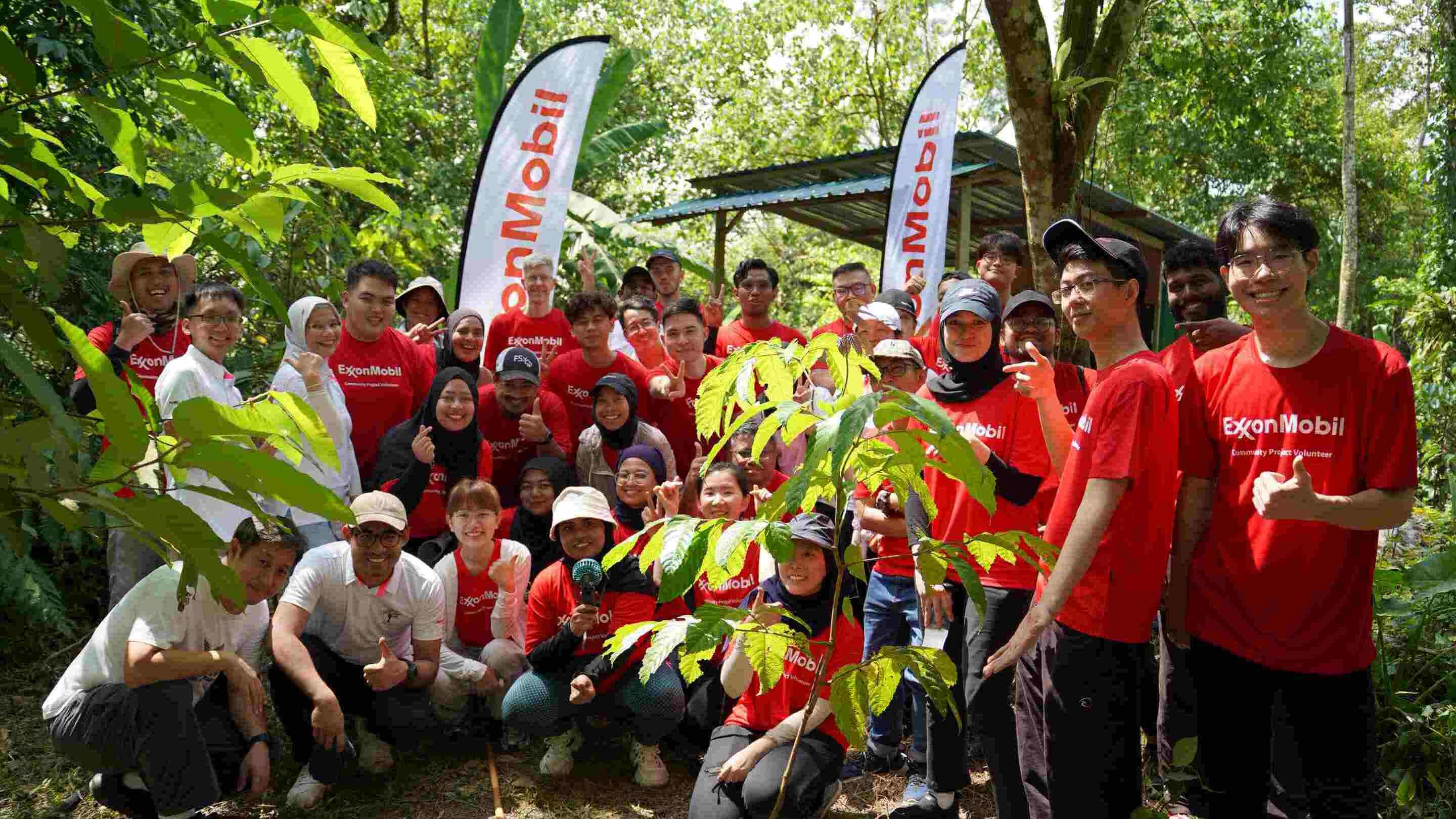 A group of ExxonMobil employee volunteers at tree planting event.
