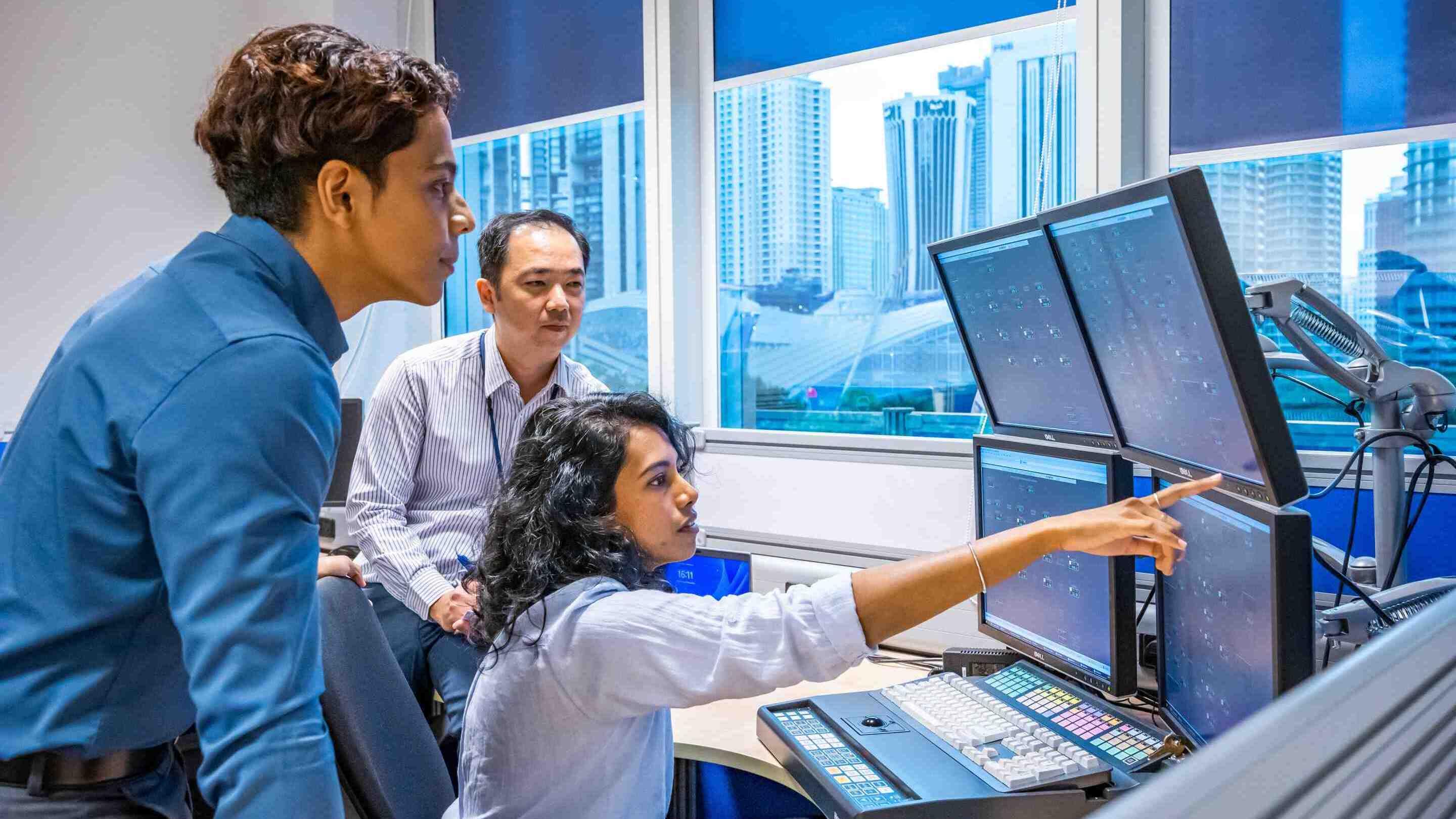 ExxonMobil Malaysia's Kuala Lumpur Technology Center employees viewing data on computer screens