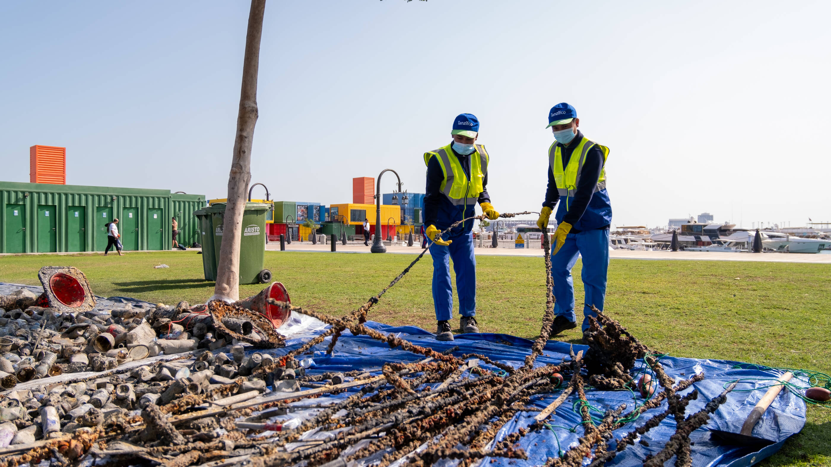 Qatari employees work on community clean-up project