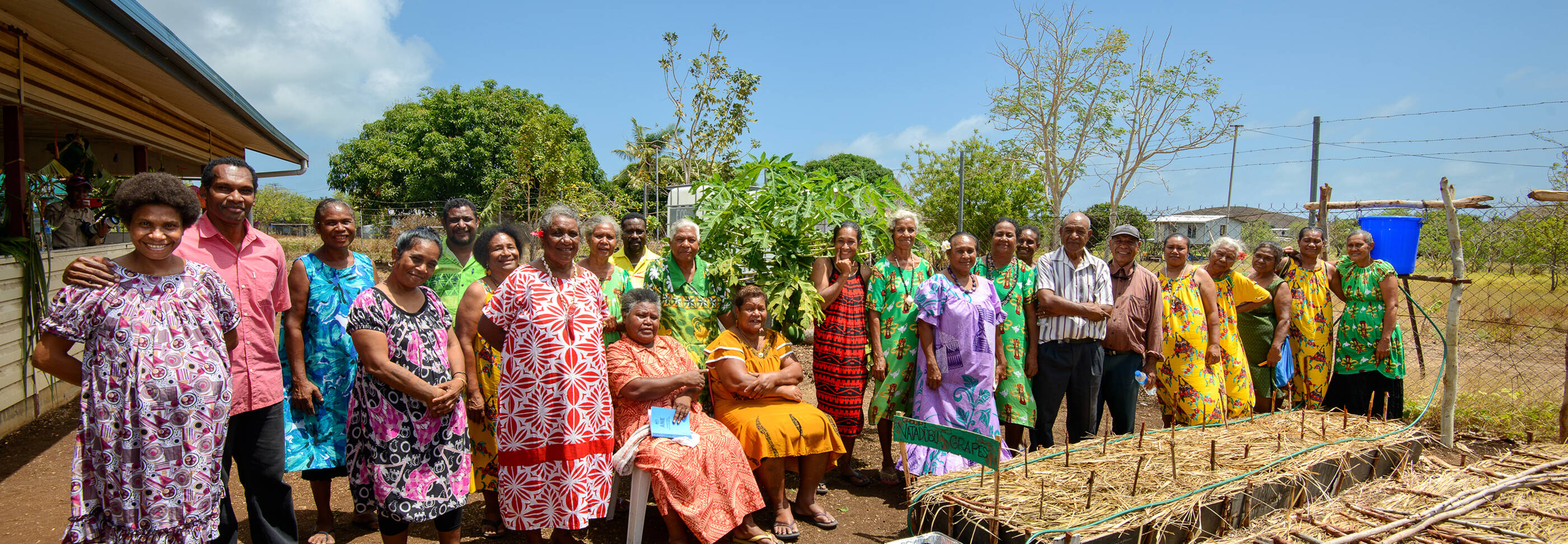 Farmers and their families posing for a picture.