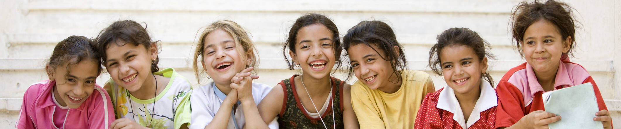 young middle eastern girls sitting on steps