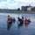 Students wading in the water looking at the oyster beds.