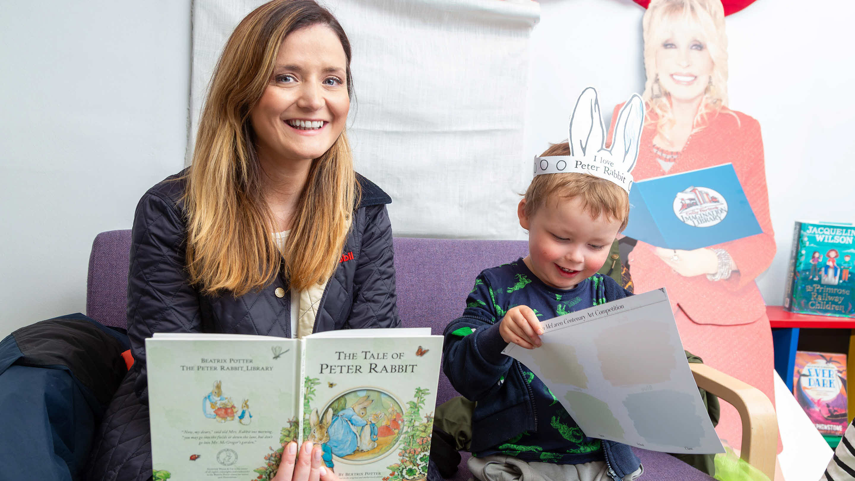 employee and child enjoying reading a book together